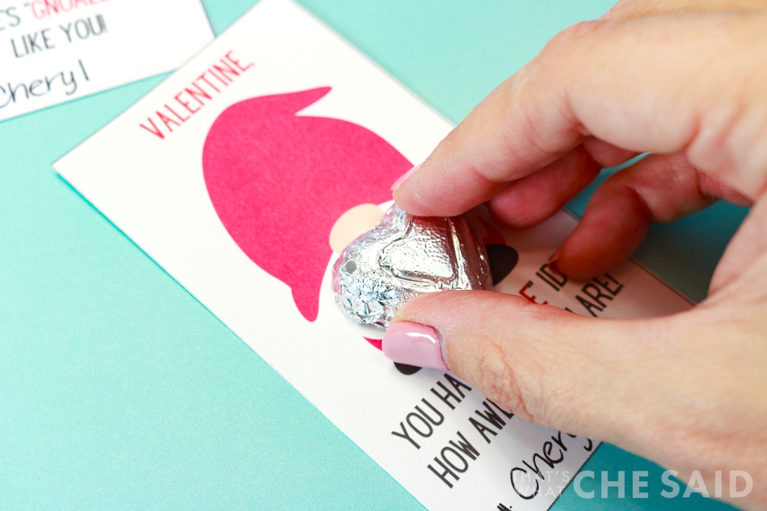 Attaching the chocolate heart to the gnome valentine