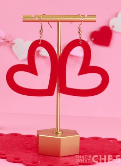 Whimsical Heart earrings cut from acrylic on xtool M1 hanging from earring stand Close up