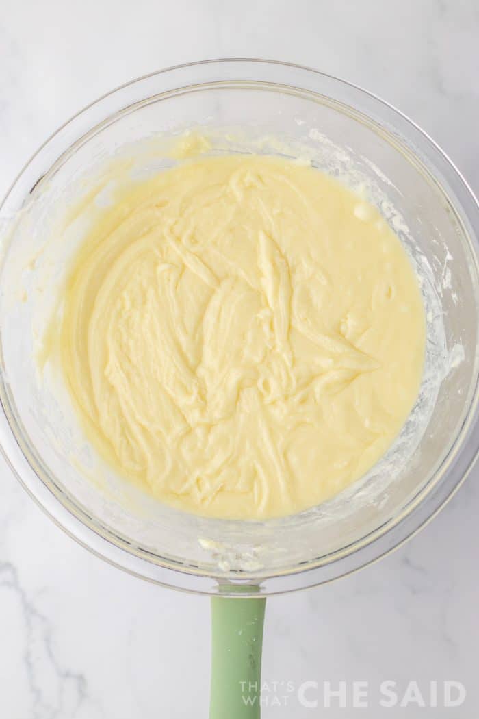 Melted, combined sugar cookie fudge in glass bowl - vertical