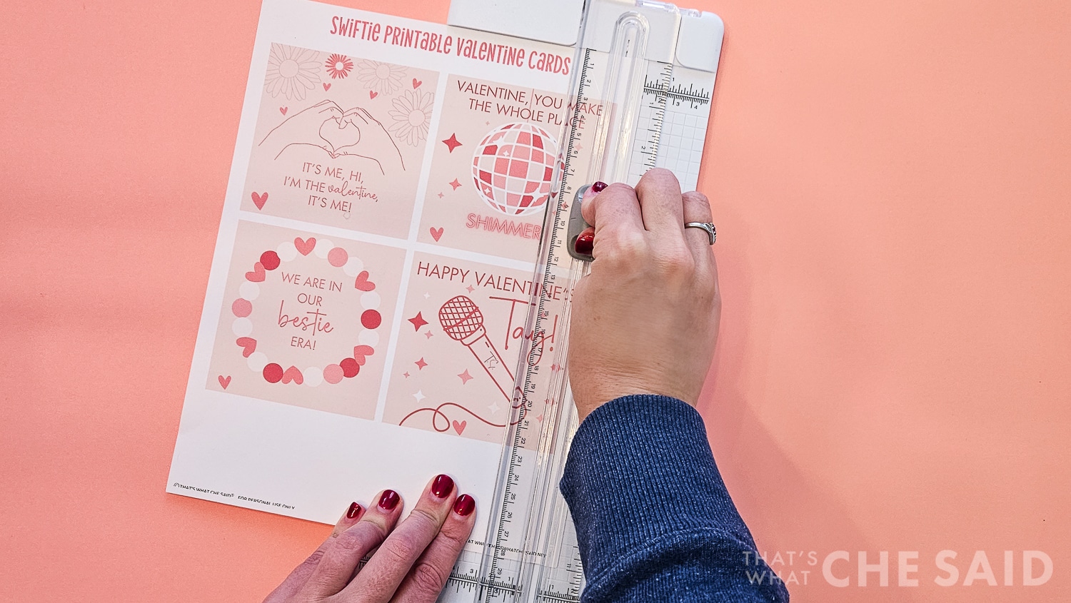 Cutting Taylor Swift Valentine printable apart into four cards with a paper cutter.