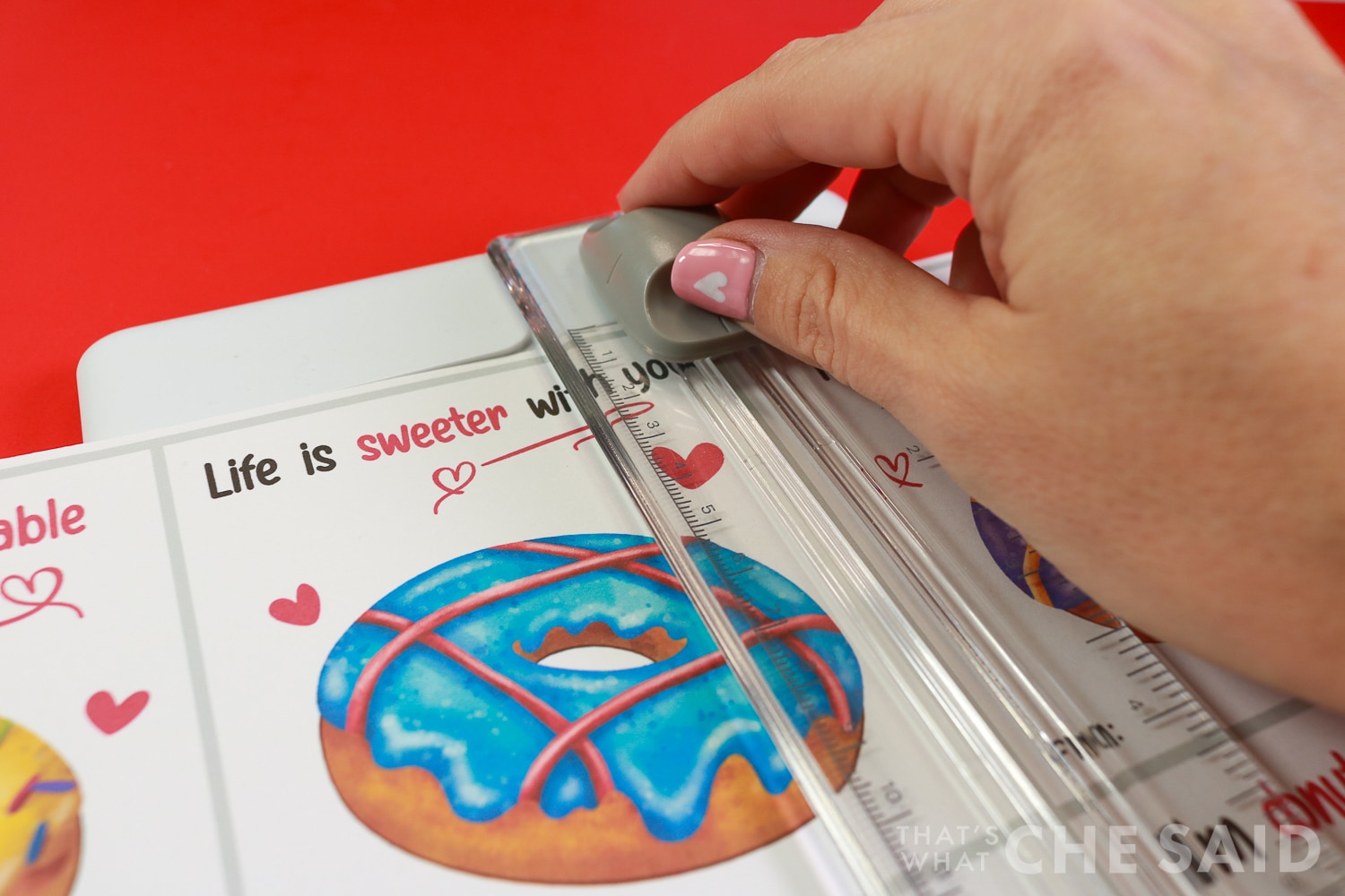 Using a paper trimmer to cut apart the free donut printable valentines