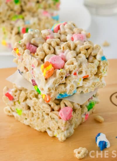 Lucky charms treat bars stacked on a cutting board square orientation
