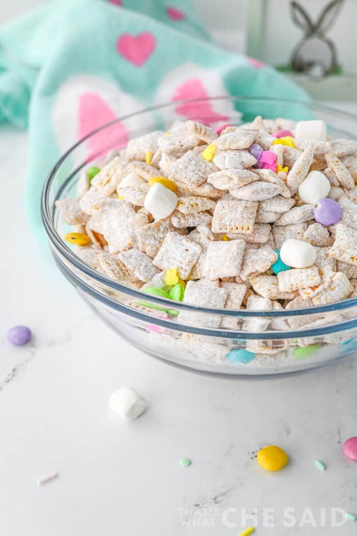 Easter puppy chow in glass bowl withe Easter fabric napkin - vertical close up