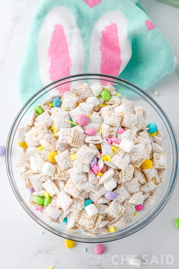 Easter puppy chow in glass bowl withe Easter fabric napkin - top down view