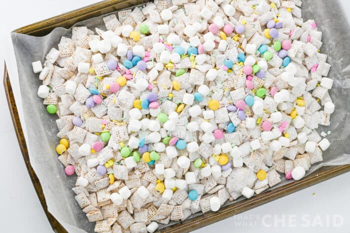 Easter addins mixed into puppy chow on baking sheet