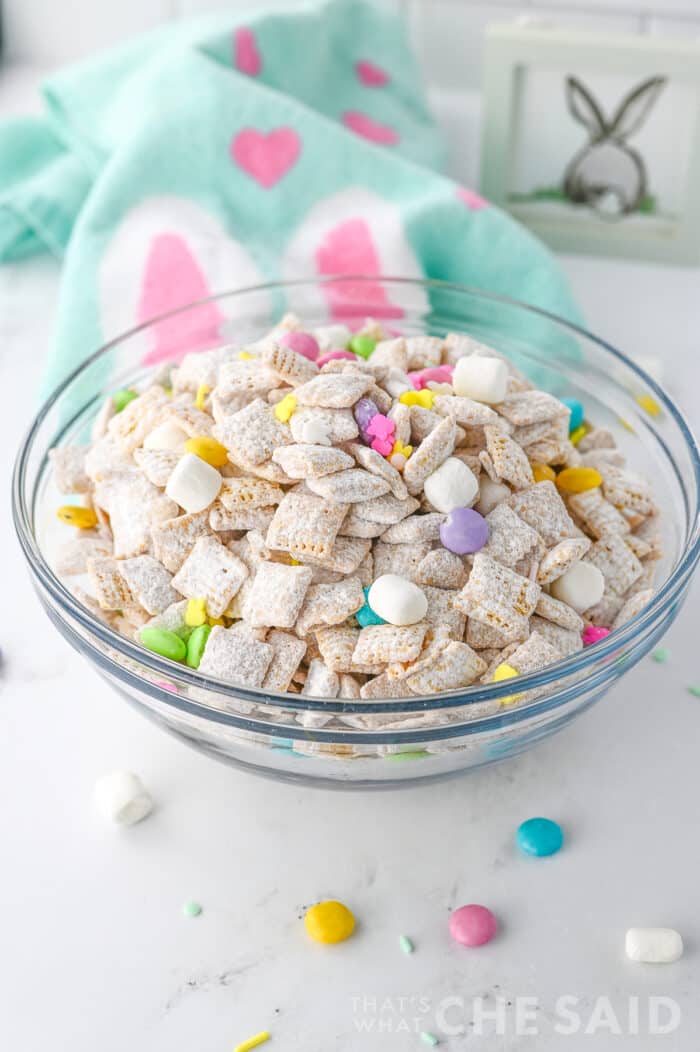 Easter puppy chow in glass bowl withe Easter fabric napkin - vertical