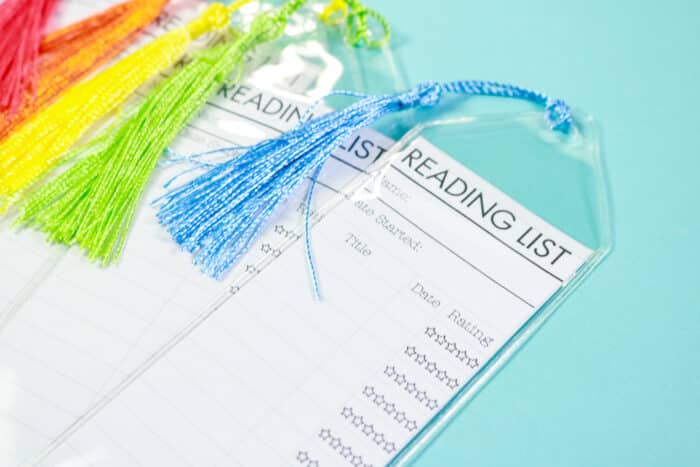 Close up of reading list bookmark inserted into plastic sleeve and has blue tassel