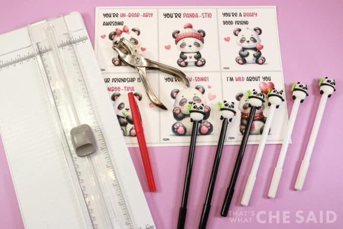Supplies for Panda Valentines: Paper cutter, free printable, hole punch, flair pen and panda pens