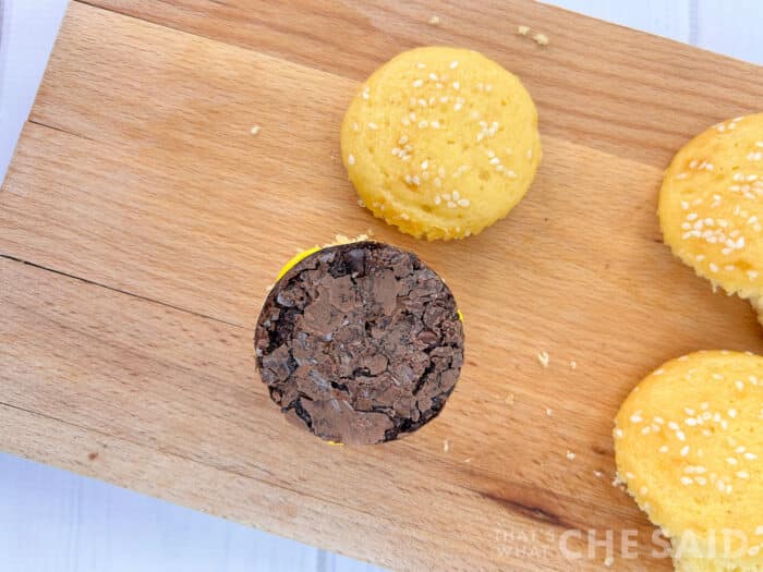 Adding Burger Brownie Pattie on top of mustard icing