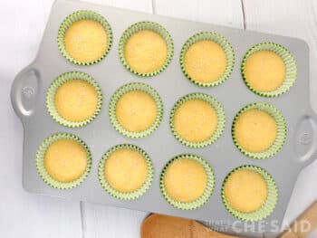 yellow cake mix in cupcake tin with sesame seeds on top for burger buns