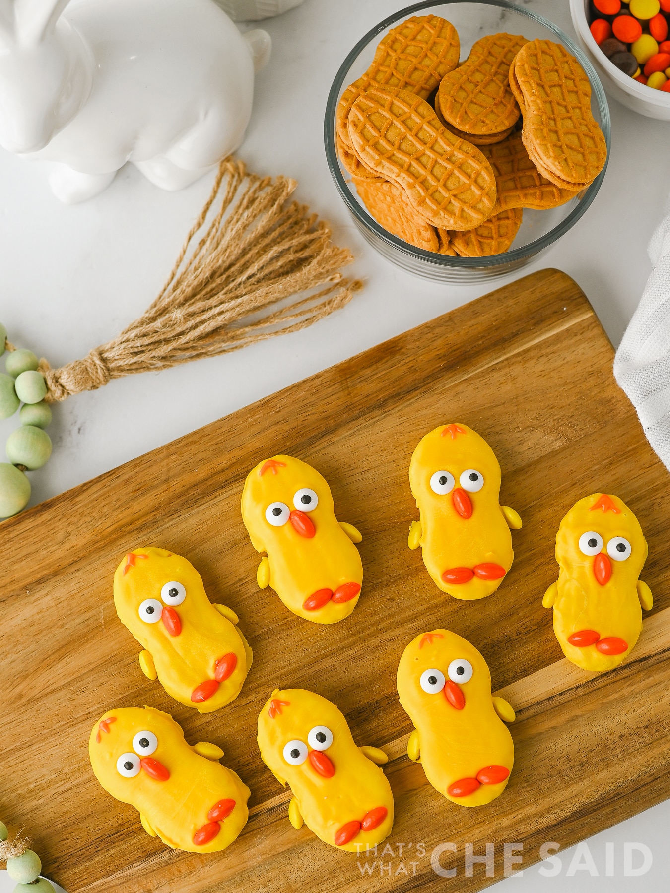 easter nutter butter chick cookies lined up on a bamboo serving dish