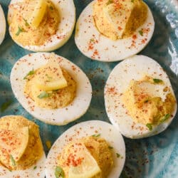 close up of deviled eggs with mini lemon wedges