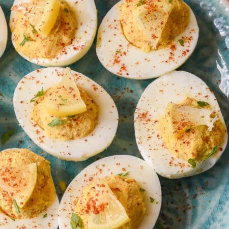 close up of deviled eggs with mini lemon wedges
