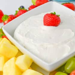 Cool Whip Fruit dip in a square dish with fruit around it, Close up Vertical Orientation
