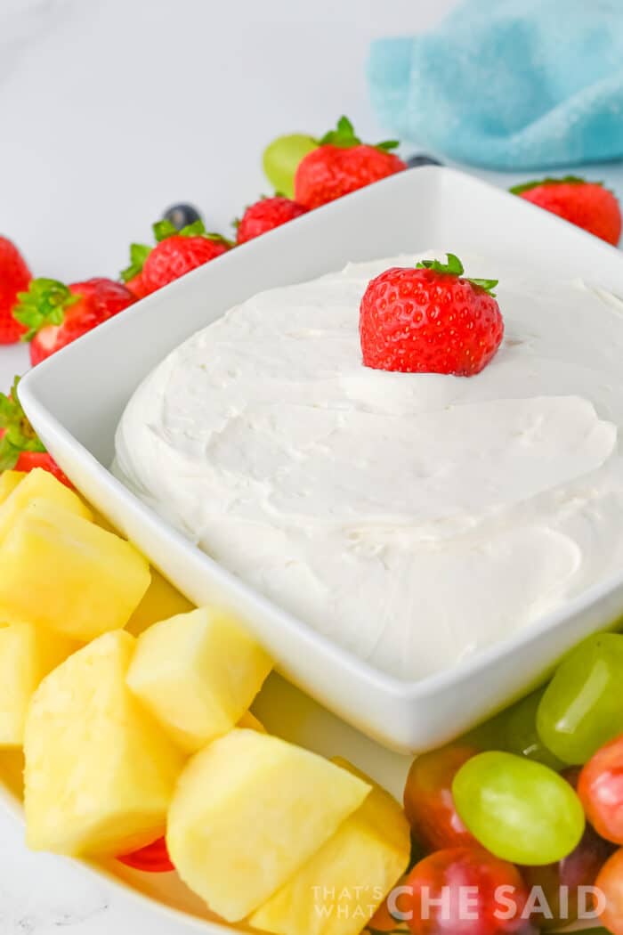 Cool Whip Fruit dip in a square dish with fruit around it, Close up Vertical Orientation