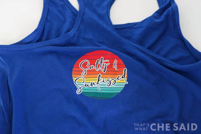 Royal Blue tank top with a DTF design pressed that reads "Salty and Sunkissed"