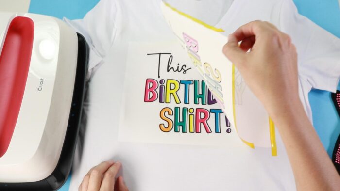 Removing the sublimation print revealing a vibrant print transfer onto the tshirt.