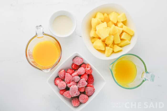 Ingredients for Lava Flow Popsicles, pineapple, strawberries, juice and cream of coconut