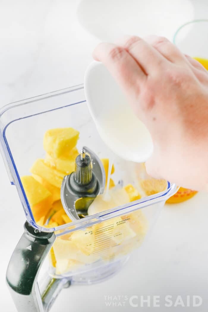 adding cream of coconut into blender
